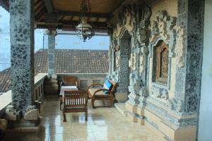 a room with chairs and a table in a building at Sunarta House Homestay in Ubud
