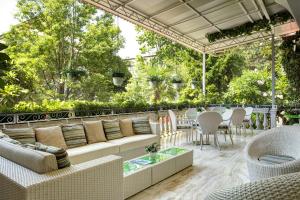 a patio with white furniture and a table and chairs at Hotel Biasutti in Venice-Lido