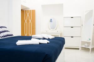 a bedroom with a blue bed with towels on it at Ottaviano Exclusive Maison in Rome