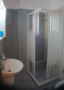 a bathroom with a shower and a toilet and a sink at Nikolaki Rooms in Porto Rafti