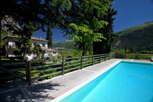 a swimming pool in front of a house at Agriturismo Maso Lizzone in Dro