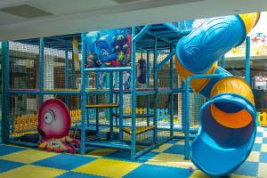 a playground with a slide and a play structure at Hotel Riviera in Mamaia