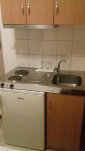 a kitchen with a sink and a counter top at Studios Kapsalas in Néa Michanióna +38 photos