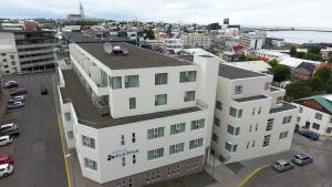an overhead view of a white building in a city at Hotel Klettur in Reykjavík