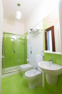 a bathroom with a sink and a toilet and a shower at Villa Elios Guesthouse in Birgi Vecchi