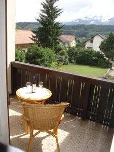 a table and chairs on a balcony with a view at Pension Katharina Frühstück ab 5 Uhr früh in Seeboden