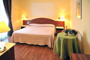 Postel nebo postele na pokoji v ubytování Hotel Benessere Villa Fiorita