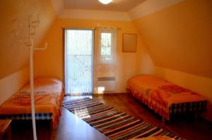 a bedroom with two beds and a window at Roosi Camping Houses in Rannaküla