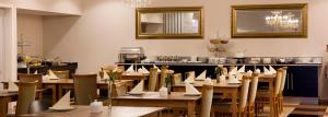 a restaurant with wooden tables and chairs with papers on them at ROSS Hotel nähe Messe Stuttgart in Stuttgart