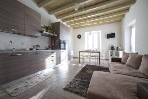 ein Wohnzimmer mit einem Sofa und einer Küche in der Unterkunft Bellavista wonderful lake view in Moltrasio