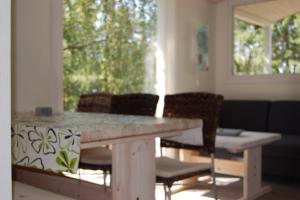 a table and chairs in a room with a window at CamperBase in Oksbøl