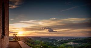 a cloud in the sky with the sunset in the background at Castello Di Mornico Losana in Mornico Losana