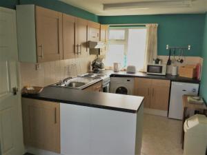 a kitchen with a sink and a counter top at Surf View Apartments in Newquay
