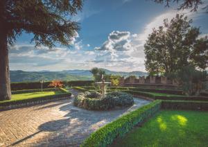 a garden with a fountain and a brick walkway at Castello Di Mornico Losana in Mornico Losana
