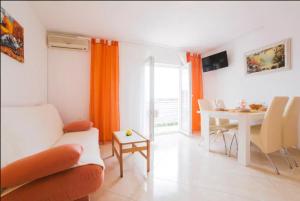 a living room with a couch and a table at Apartments Kristian in Bol