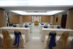 a banquet hall with white tables and blue bows at Palm Paradise Resort in Ao Nang Beach