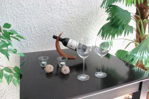 a table with two glasses and a bottle of wine at Villa Relax - Ferienwohnungen & Hallenbad & Relaxgarten in Bodenmais