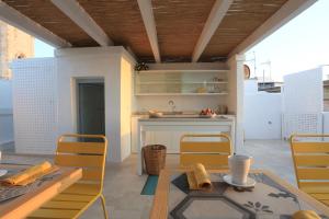 a kitchen with a table and chairs and a sink at FONTEblu B&B in Polignano a Mare +37 photos