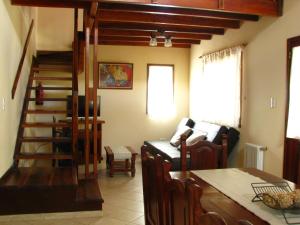 Una sala de estar con escalera y un comedor. en Don Gregorio, en Merlo 108 fotos más