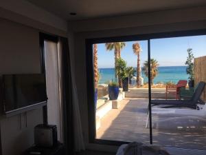 a bedroom with a view of the ocean from a balcony at H Boutique Peña Parda in La Herradura