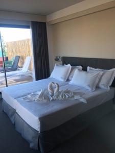 a large bed with two towels on top of it at H Boutique Peña Parda in La Herradura