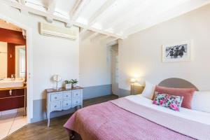 a bedroom with a bed and a dresser at Hôtel L'Adresse in Tours