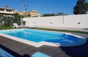 a swimming pool in the backyard of a house at Casa do Cerro in Madalena