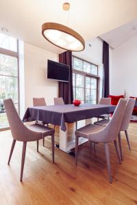a dining room with a blue table and chairs at Villa Comfort in Palanga