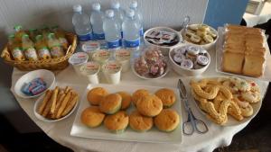 a table with food and bottles of water and drinks at Suite&B in Scicli