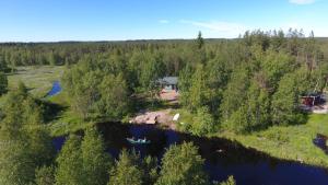 an aerial view of a house and a boat on a river at ILO103 in Huhus
