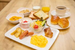 a table with a plate of breakfast foods and coffee at Sotetsu Fresa Inn Kyoto-Shijokarasuma in Kyoto