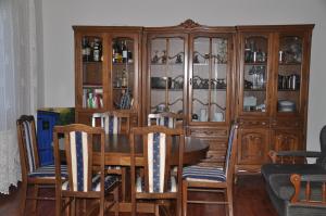 a dining room with a table and a china cabinet at Guesthouse Djurić in Negotin