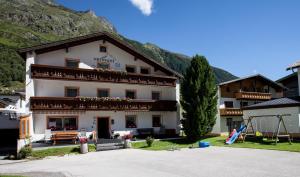 a large white building in front of a mountain at Vermunt 19a in Galtür