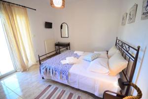 A bed or beds in a room at Christina Apartment