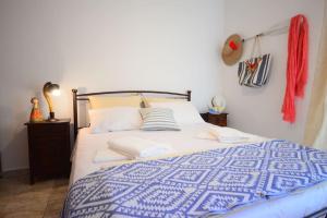 A bed or beds in a room at Christina Apartment