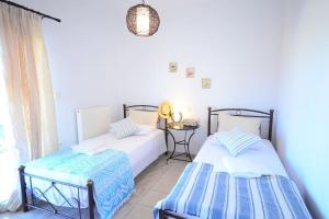 A bed or beds in a room at Christina Apartment