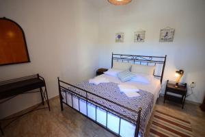 A bed or beds in a room at Christina Apartment
