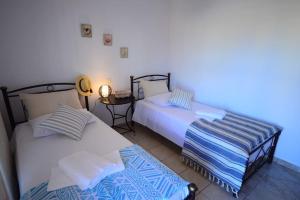 A bed or beds in a room at Christina Apartment