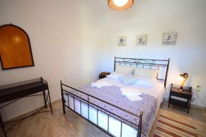 A bed or beds in a room at Christina Apartment
