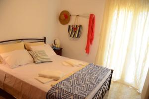 A bed or beds in a room at Christina Apartment