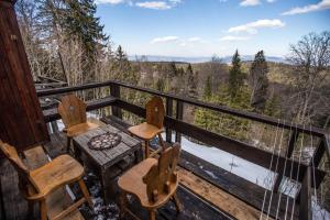 two chairs and a table on the balcony of a cabin at Chalet Baluma Maluba in Jahorina