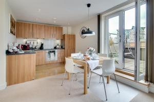 a kitchen and dining room with a table and chairs at The Class Place in Birmingham
