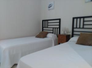 Łóżko lub łóżka w pokoju w obiekcie Casa Rosie