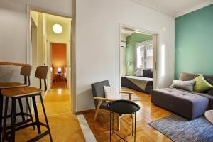 ein Wohnzimmer mit einem Sofa und einem Bett in der Unterkunft Athens Centre Apartment in Athen