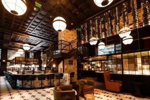 a large room with a library with chairs and tables at Hilton Norfolk The Main in Norfolk