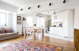 a kitchen and living room with a table and chairs at Diana's Flat-the best-Bucharest - Old City in Bucharest