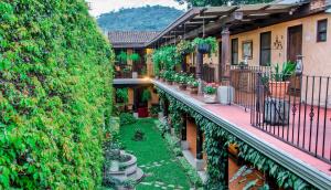 an apartment balcony with plants and a garden at Hotel Meson del Valle by AHS in Antigua Guatemala