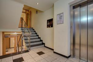 a lobby with a staircase in a building at Trip Inn Hotel Conti in Cologne