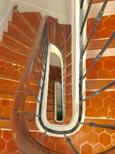 a circular mirror on a brick stair case at My rima in Antibes