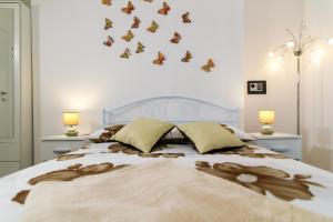 a bedroom with a bed with butterflies on the wall at Apartments Trend 2 in Rijeka